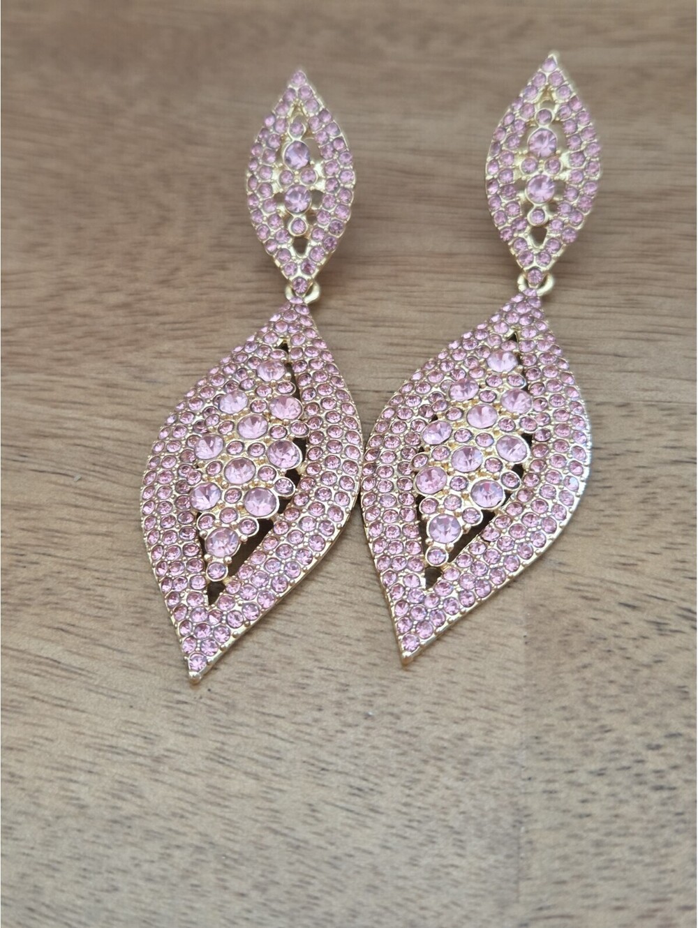 Gorgeous statement drop earrings featuring sparkling pink...
